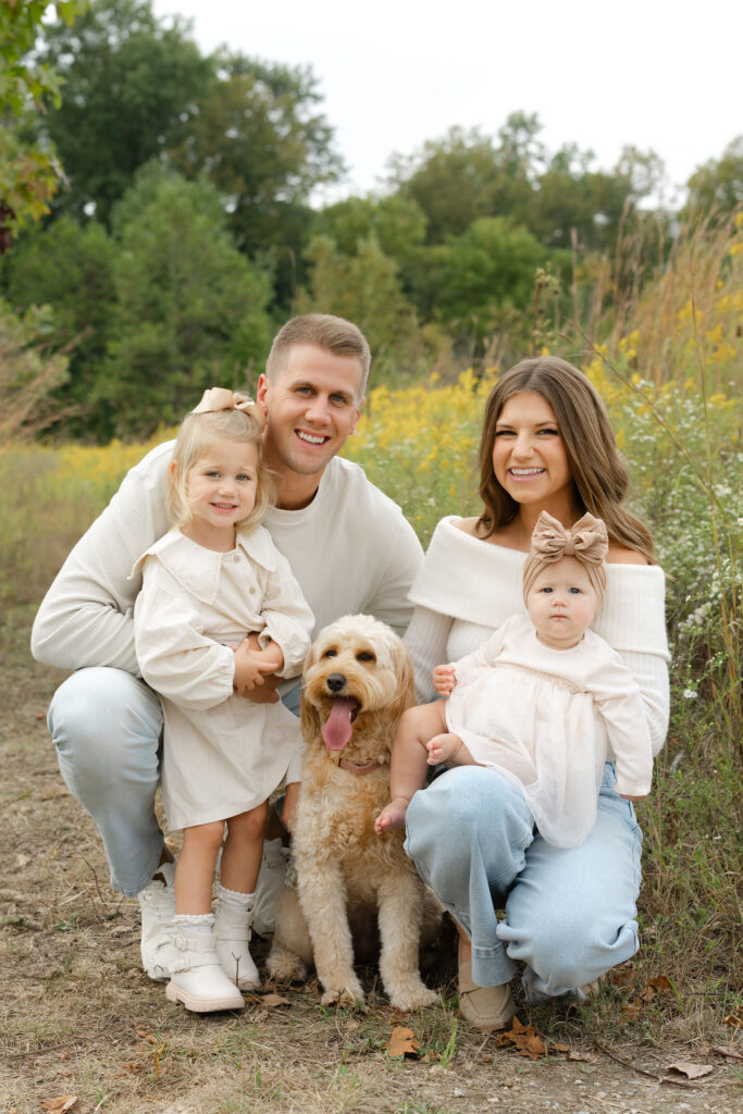 Family and dog smiling during fall family photos at West Park in with Capturing Simplicity Photography