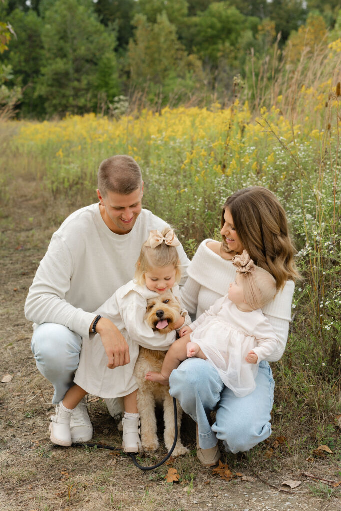Family hugging dog during fall family photos at West Park in with Capturing Simplicity Photography