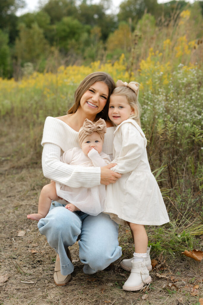 Daughters hugging mom during fall family photos at West Park in with Capturing Simplicity Photography