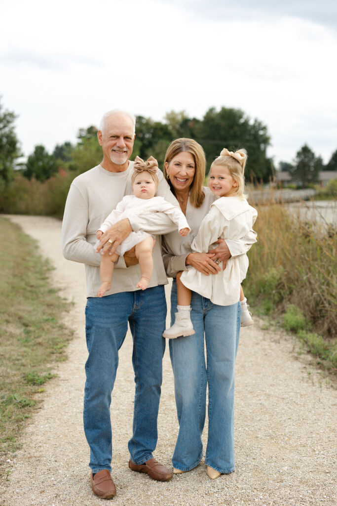 Grandparents snuggling girls during fall family photos at West Park in with Capturing Simplicity Photography
