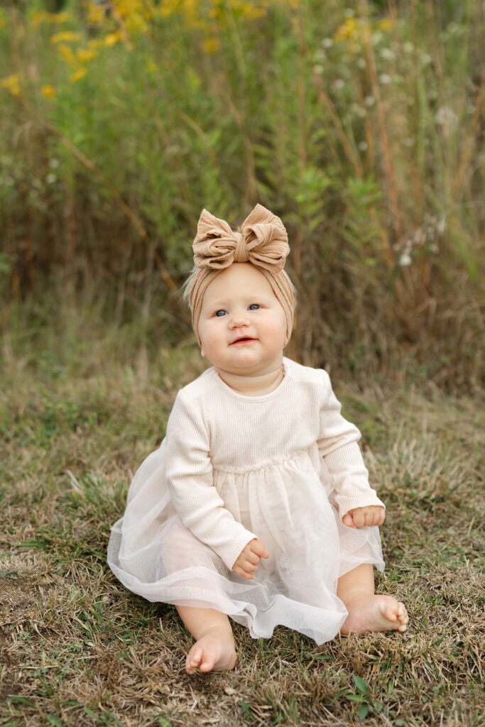 Baby girl smiling during fall family photos at West Park in with Capturing Simplicity Photography