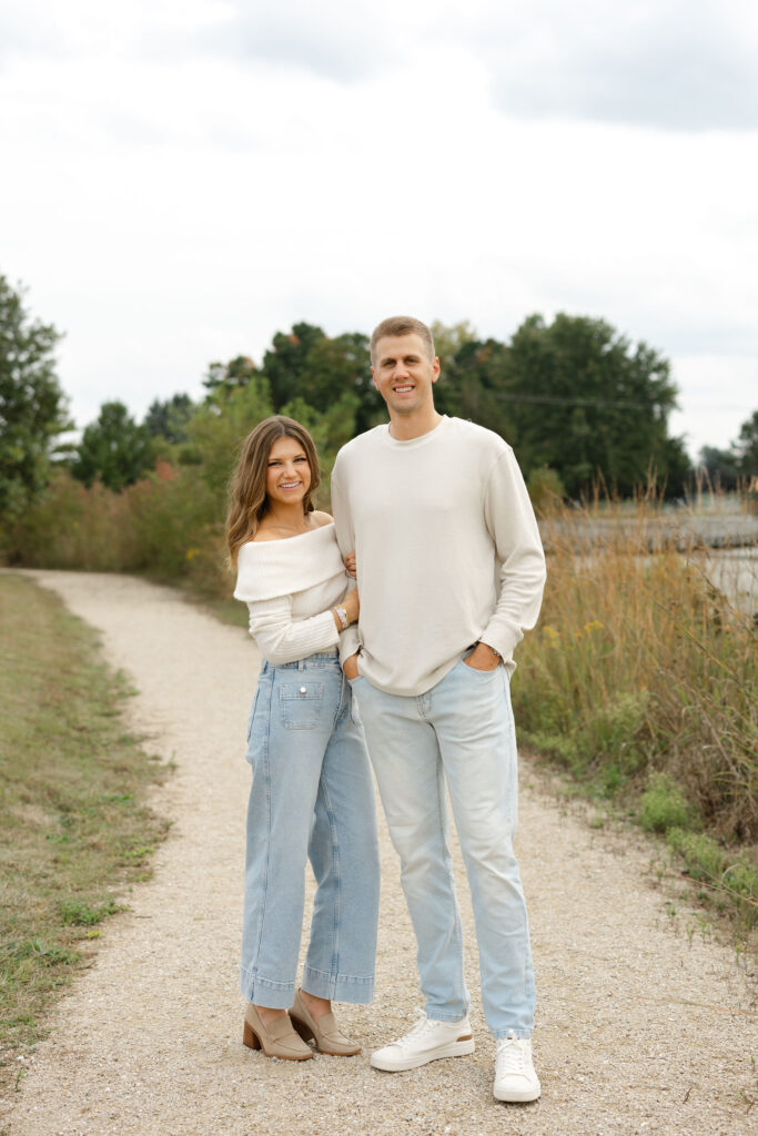 Mom and dad smiling during fall family photos at West Park in with Capturing Simplicity Photography