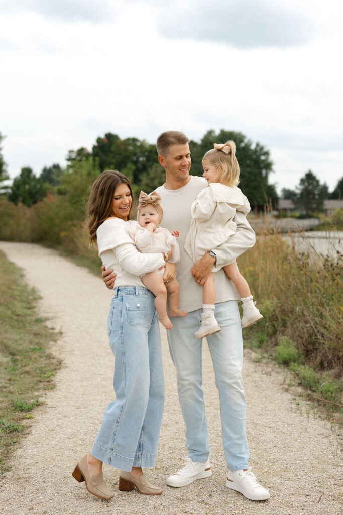 Family smiling and laughing during fall family photos at West Park in with Capturing Simplicity Photography