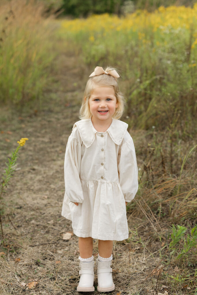 Little girl smiling during fall family photos at West Park in with Capturing Simplicity Photography