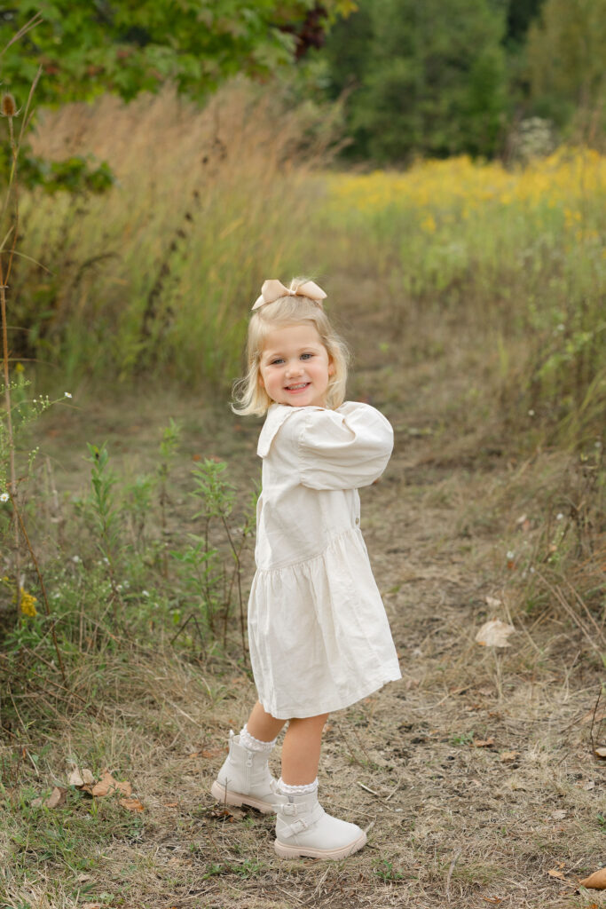 Little girl dancing during fall family photos at West Park in with Capturing Simplicity Photography