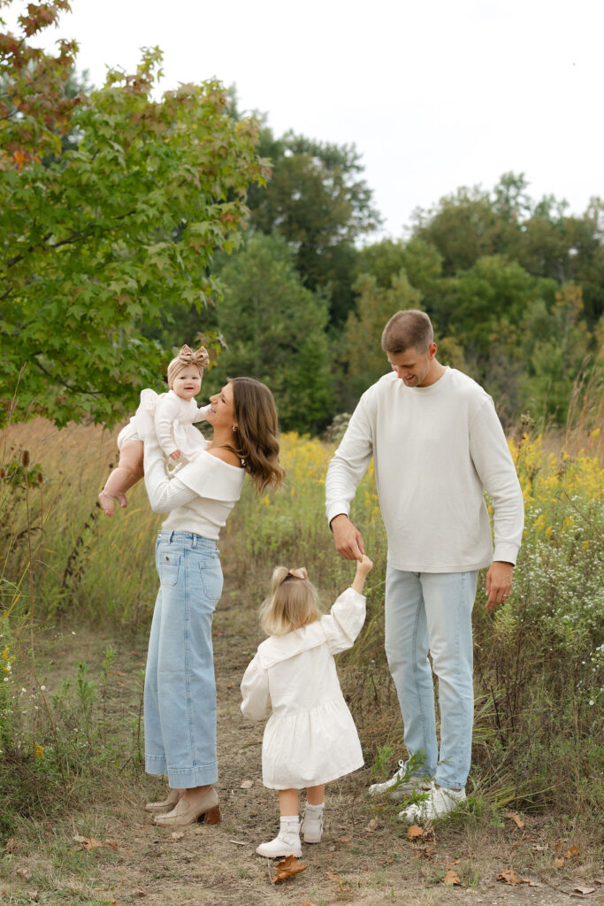 Family playing during fall family photos at West Park in with Capturing Simplicity Photography