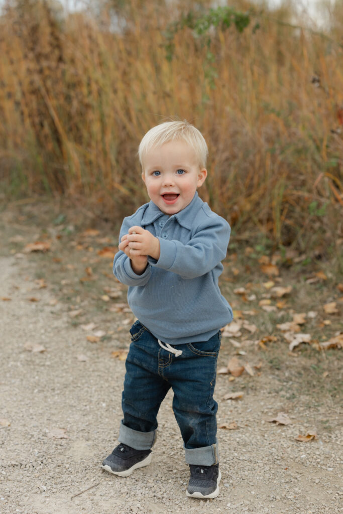 Little boy throwing rocks during Fall Mini Sessions at West Park with Capturing Simplicity Photography