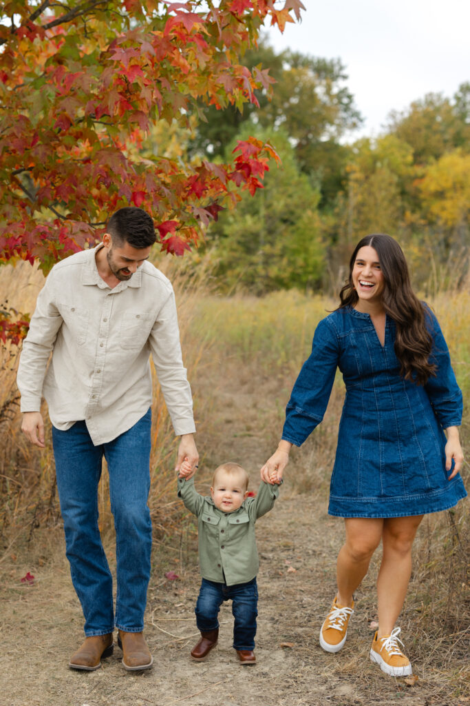 Family walking through a path during Fall Mini Sessions at West Park with Capturing Simplicity Photography