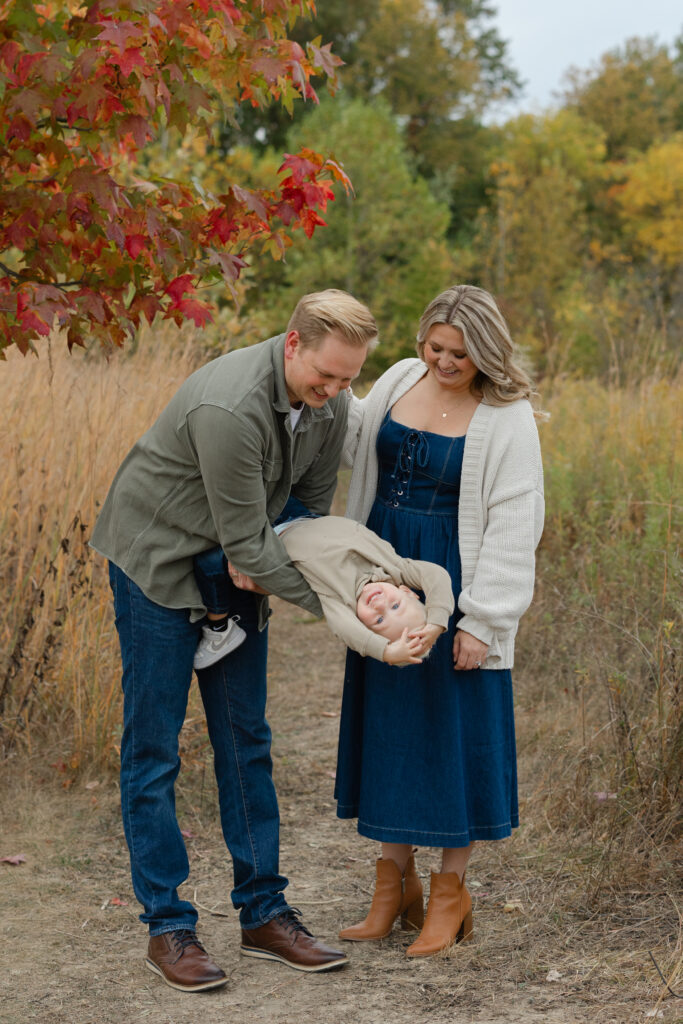 Family playing with little boy during Fall Mini Sessions at West Park with Capturing Simplicity Photography