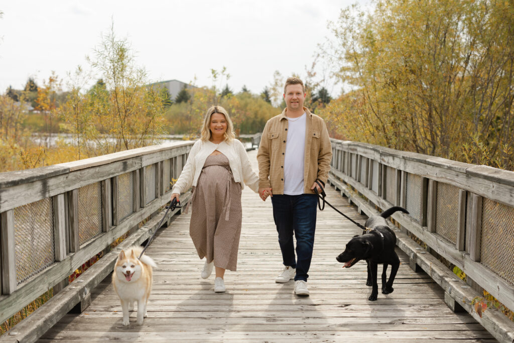 couple walking dogs during Fall Mini Sessions at West Park with Capturing Simplicity Photography