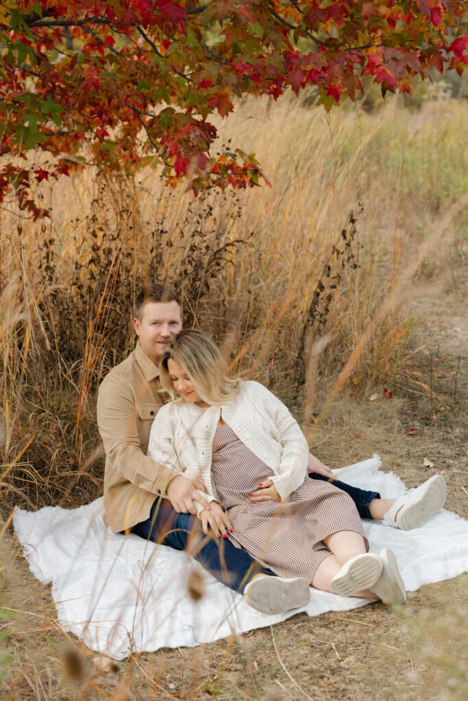 couple snuggled on blanket during Fall Mini Sessions at West Park with Capturing Simplicity Photography