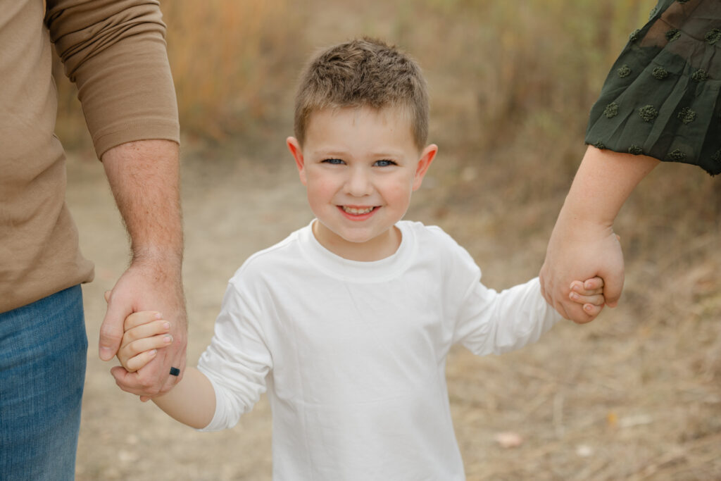 Little oby walking during Fall Mini Sessions at West Park with Capturing Simplicity Photography