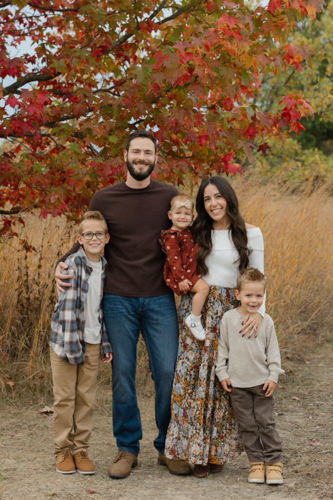 Family hugging during Fall Mini Sessions at West Park with Capturing Simplicity Photography