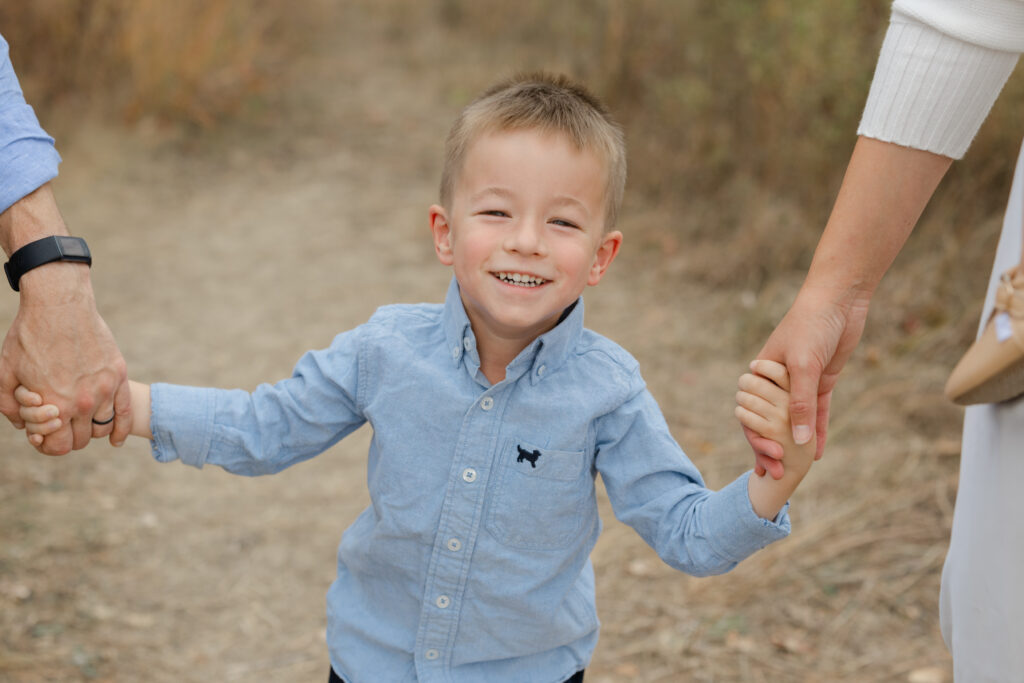 Little boy laughing during Fall Mini Sessions at West Park with Capturing Simplicity Photography