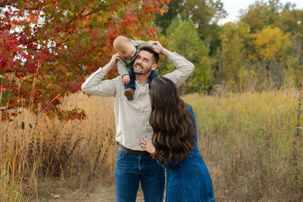 Little boy laughing with dad during Fall Mini Sessions at West Park with Capturing Simplicity Photography