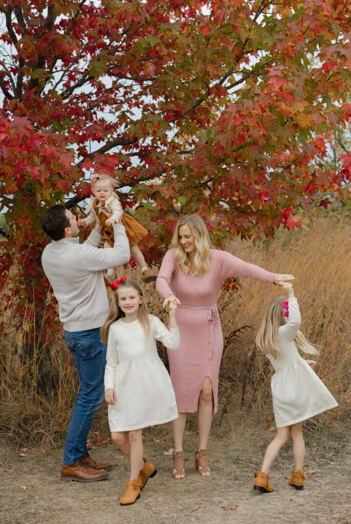 Family dancing during Fall Mini Sessions at West Park with Capturing Simplicity Photography
