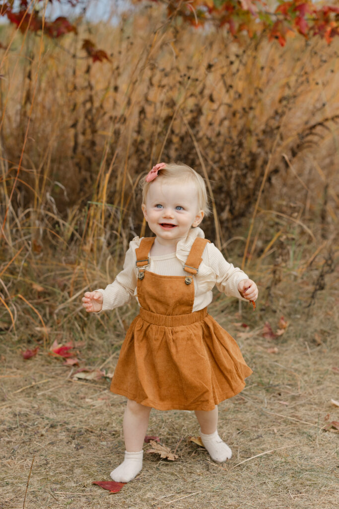 Little girl laughing during Fall Mini Sessions at West Park with Capturing Simplicity Photography