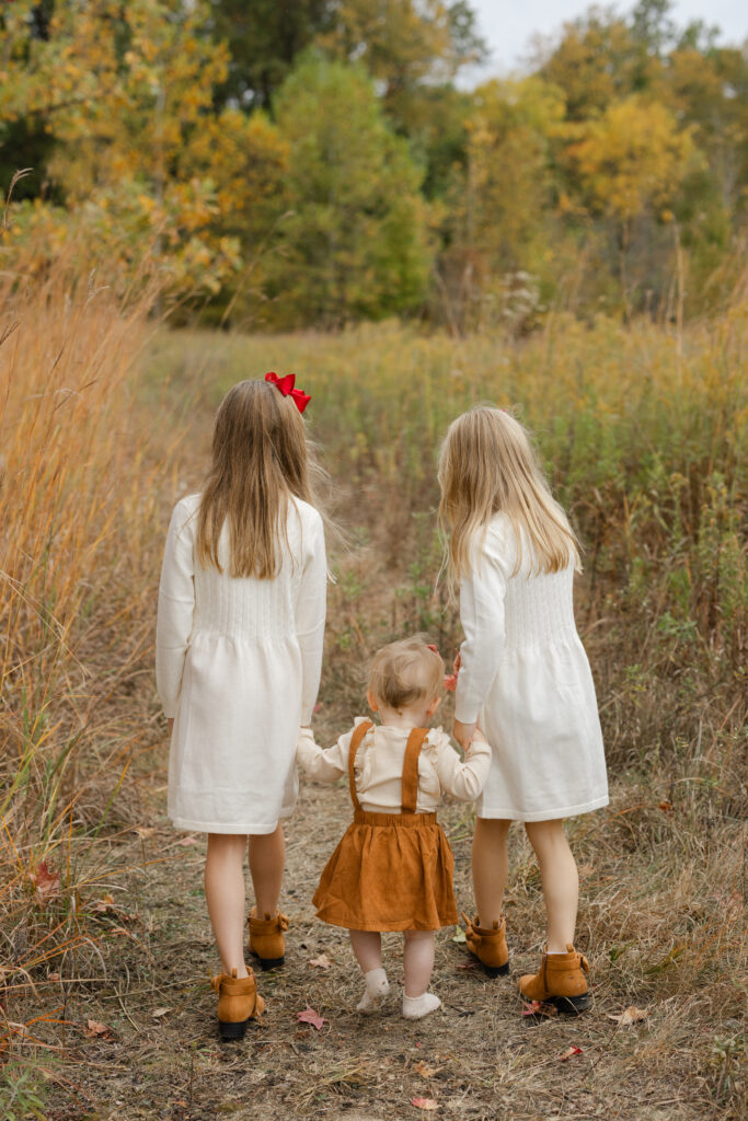 Sisters walking during Fall Mini Sessions at West Park with Capturing Simplicity Photography