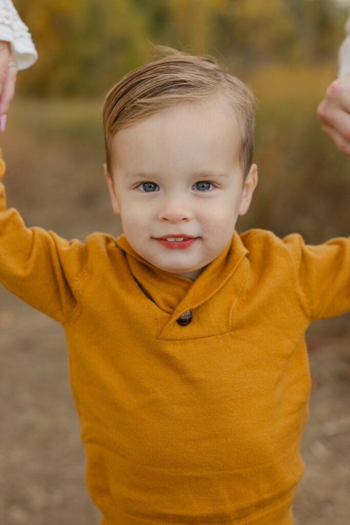 Big brother smiling during Fall Mini Sessions at West Park with Capturing Simplicity Photography