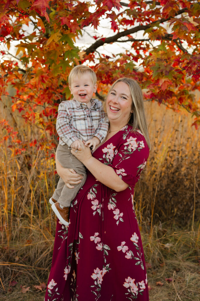 Mom lifting little boy during Fall Mini Sessions at West Park with Capturing Simplicity Photography