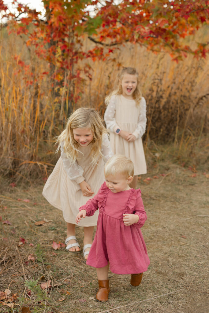 Sisters exploring during Fall Mini Sessions at West Park with Capturing Simplicity Photography