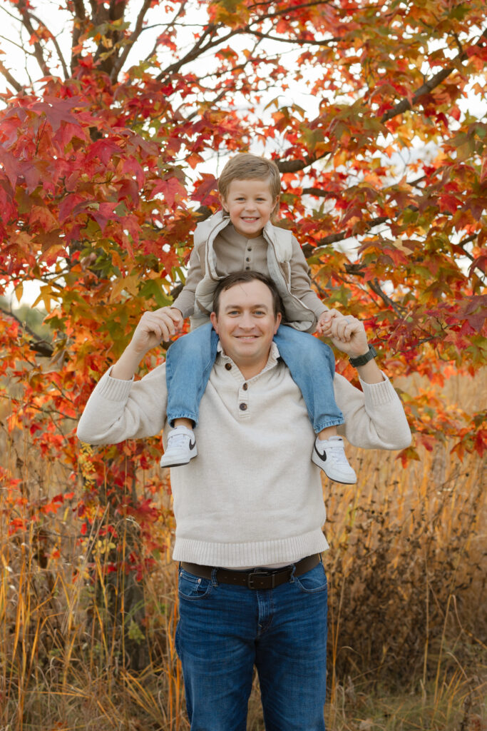 son on dads shoulders during Fall Mini Sessions at West Park with Capturing Simplicity Photography