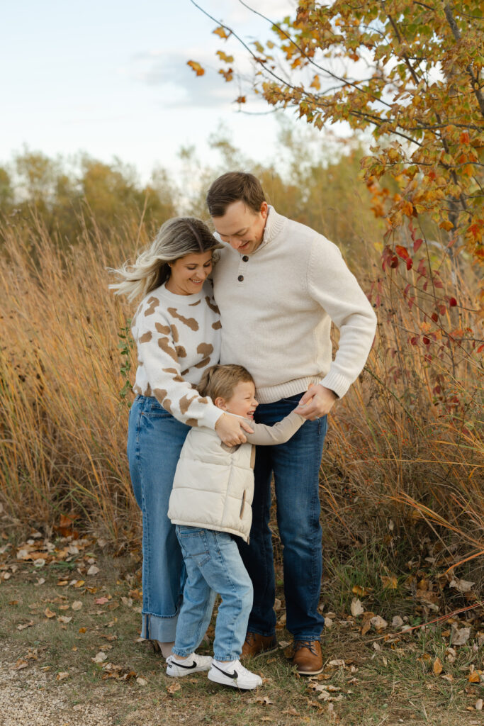son hugging parents during Fall Mini Sessions at West Park with Capturing Simplicity Photography