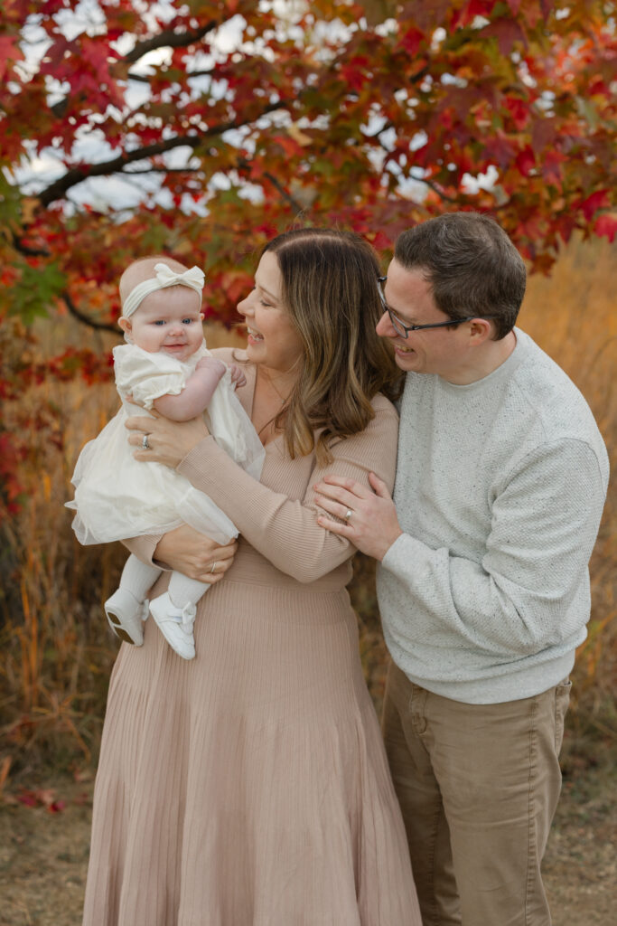 Family holding baby during Fall Mini Sessions at West Park with Capturing Simplicity Photography