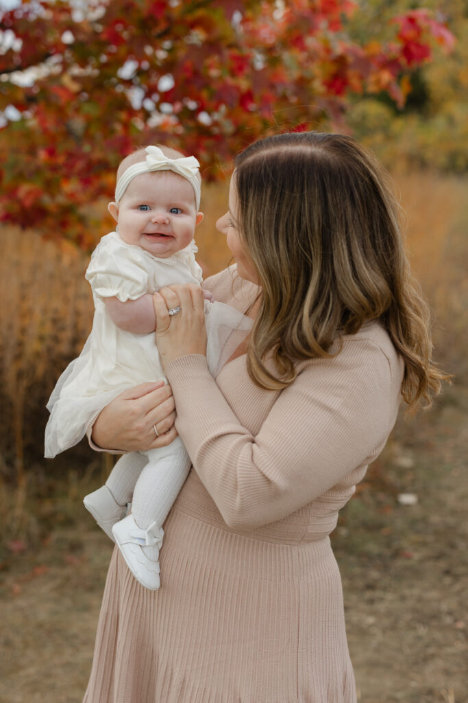 mom holding baby during Fall Mini Sessions at West Park with Capturing Simplicity Photography