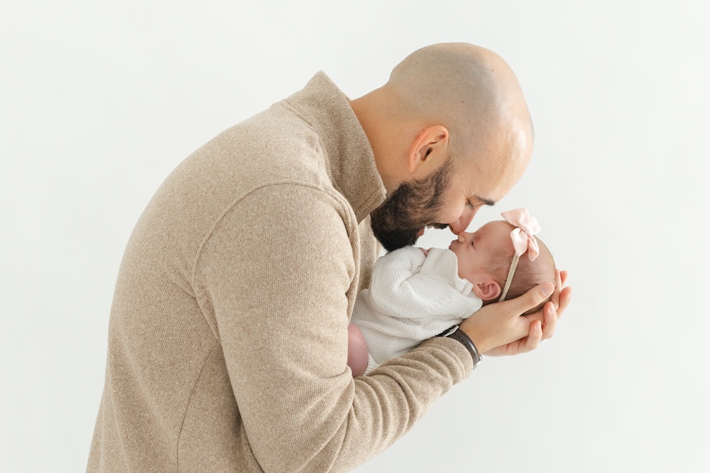 Dad giving baby girl eskimo kisses during newborn photos with Indianapolis Newborn Photographer Capturing Simplicity Photography