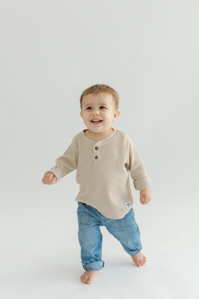 Little boy playing during newborn photos with Indianapolis Newborn Photographer Capturing Simplicity Photography