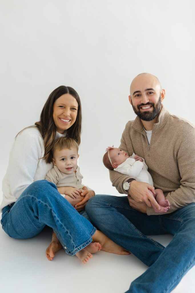 Family snuggling during newborn photos with Indianapolis Newborn Photographer Capturing Simplicity Photography