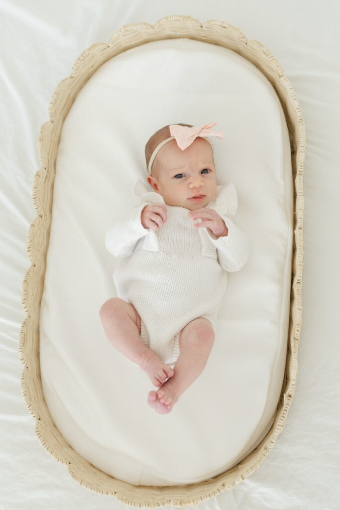 Newborn girl in infant basket during newborn photos with Indianapolis Newborn Photographer Capturing Simplicity Photography