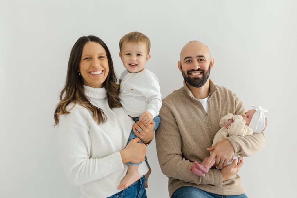 Family portrait with solid white background during newborn photos with Indianapolis Newborn Photographer Capturing Simplicity Photography