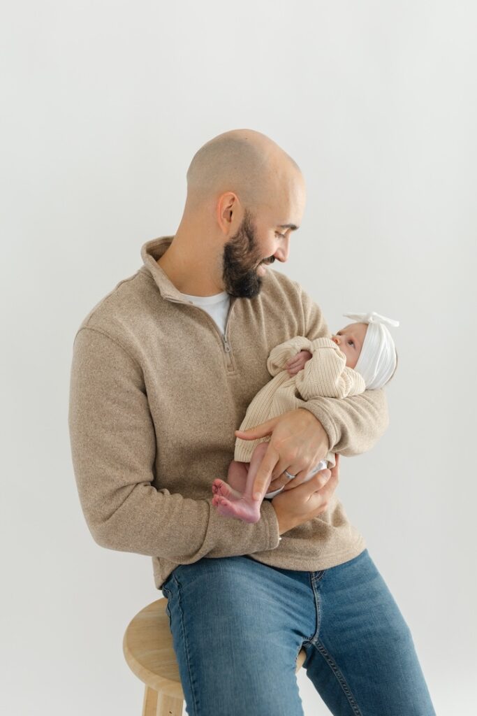 Dad holding little girl during newborn photos with Indianapolis Newborn Photographer Capturing Simplicity Photography