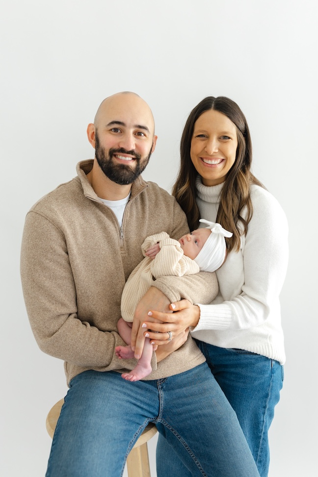 Mom and dad holding baby girl during newborn photos with Indianapolis Newborn Photographer Capturing Simplicity Photography