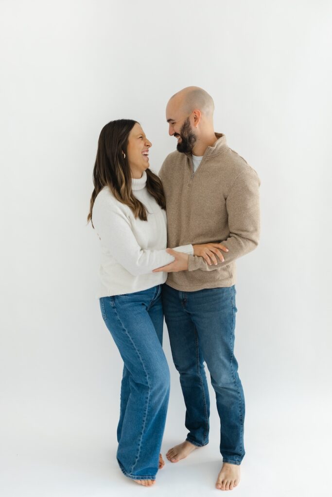 Mom and dad looking towards each other during newborn photos with Indianapolis Newborn Photographer Capturing Simplicity Photography
