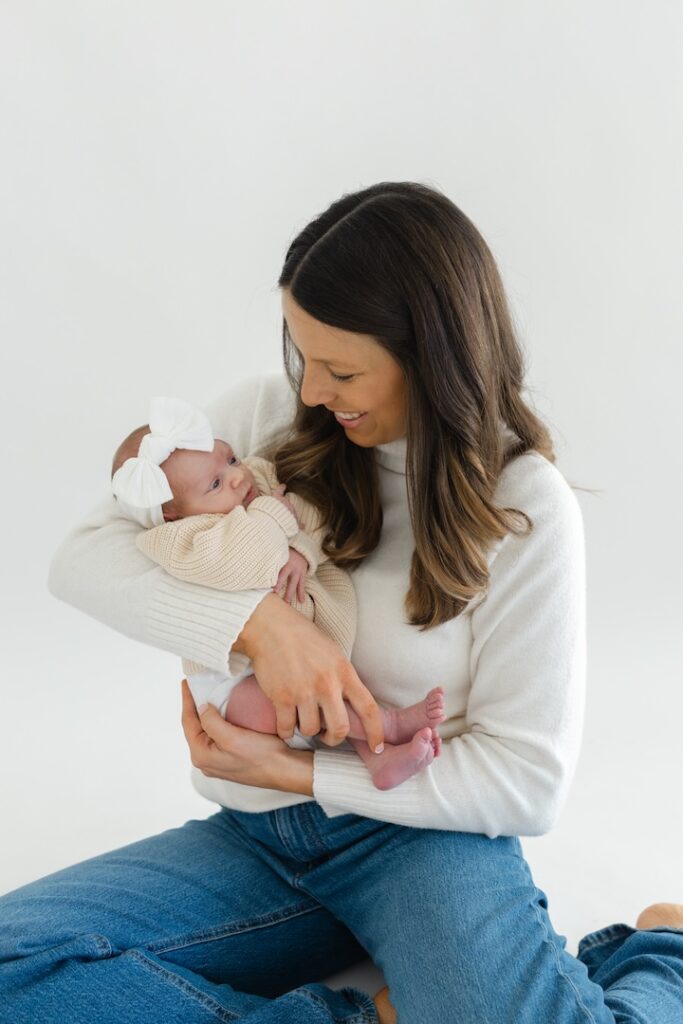 Mom holding baby girl during newborn photos with Indianapolis Newborn Photographer Capturing Simplicity Photography