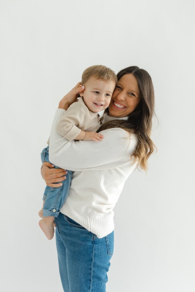 Mom snuggling son in during newborn photos with Indianapolis Newborn Photographer Capturing Simplicity Photography