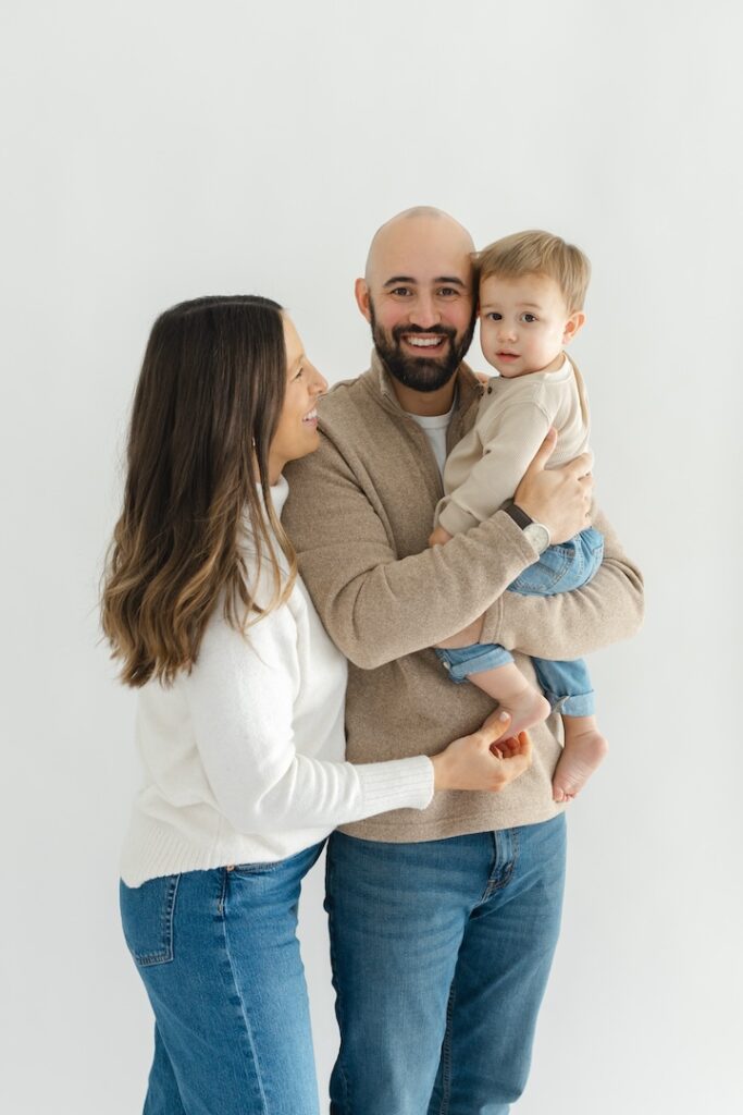 Mom hugging dad and son during newborn photos with Indianapolis Newborn Photographer Capturing Simplicity Photography