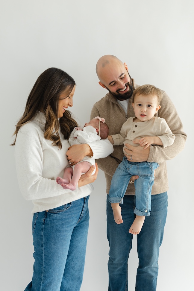 Family of four in studio during newborn photos with Indianapolis Newborn Photographer Capturing Simplicity Photography
