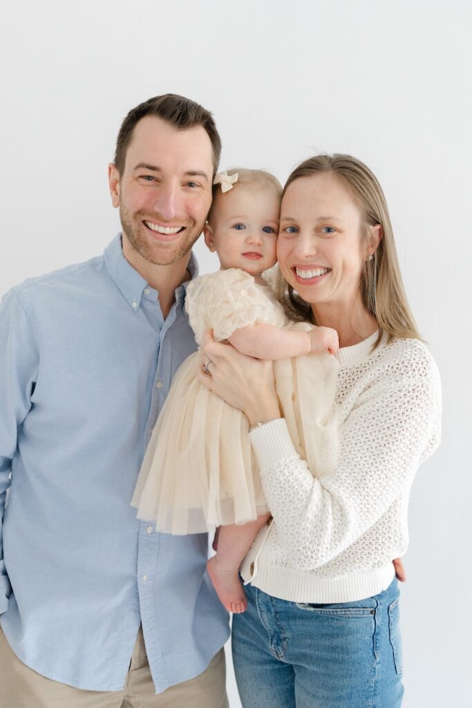 Family portrait with their faces close together during first birthday photos in Indianapolis with Capturing Simplicity Photography