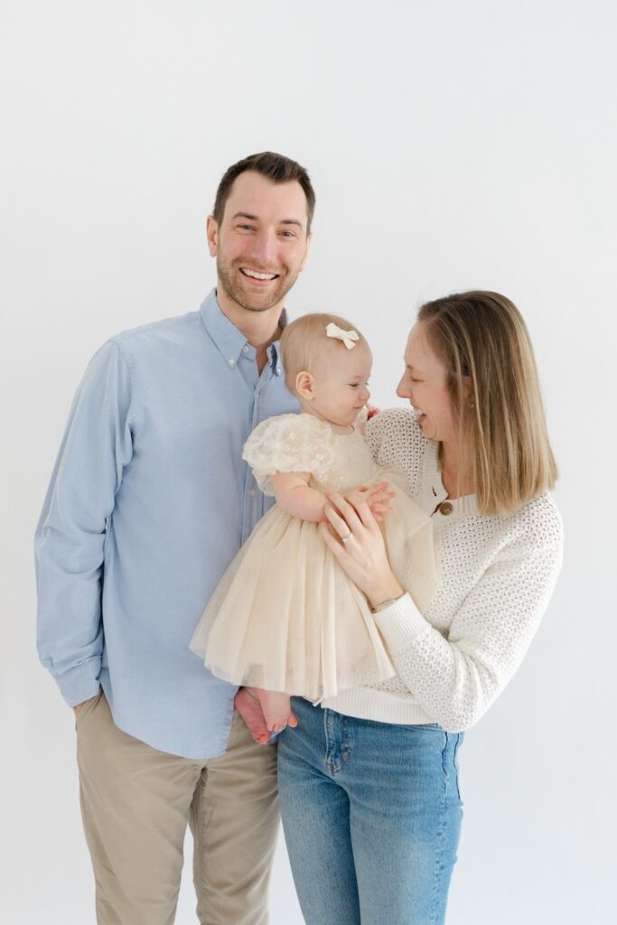 Mom holding baby girl and laughing with her during first birthday photos in Indianapolis with Capturing Simplicity Photography